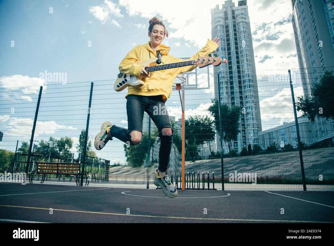 Happy sporty woman jumping hi-res stock photography and images - Alamy