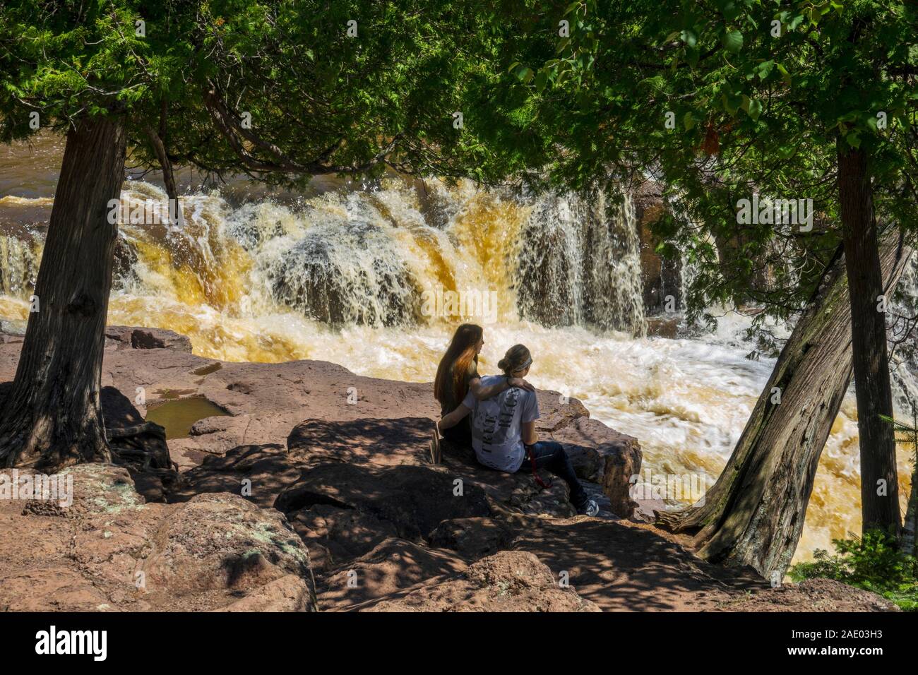Femal couple in love bonding at Lower Falls Split Rock State Park Minnesota Stock Photo