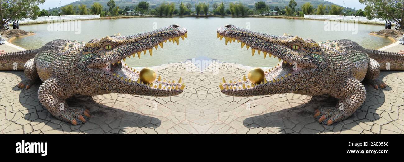 Crocodile Sculpture, Wat Pa Huay Lad, Loei, Isaan, Northeast Thailand, Panorama, Body with Different Mosaic Stones, Golden Teeth, Golden Ball Stock Photo