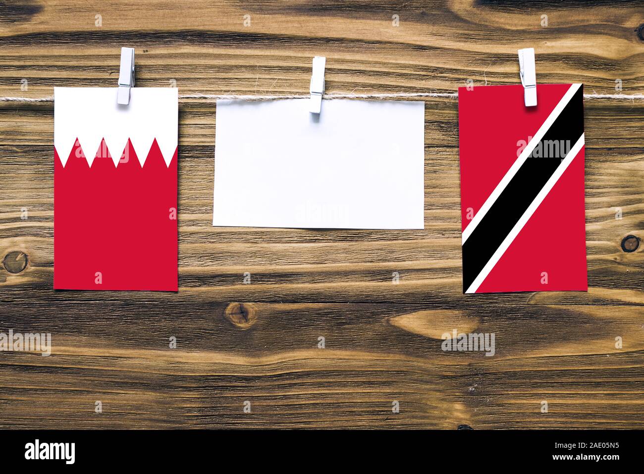 Hanging flags of Bahrain and Trinidad And Tobago attached to rope with