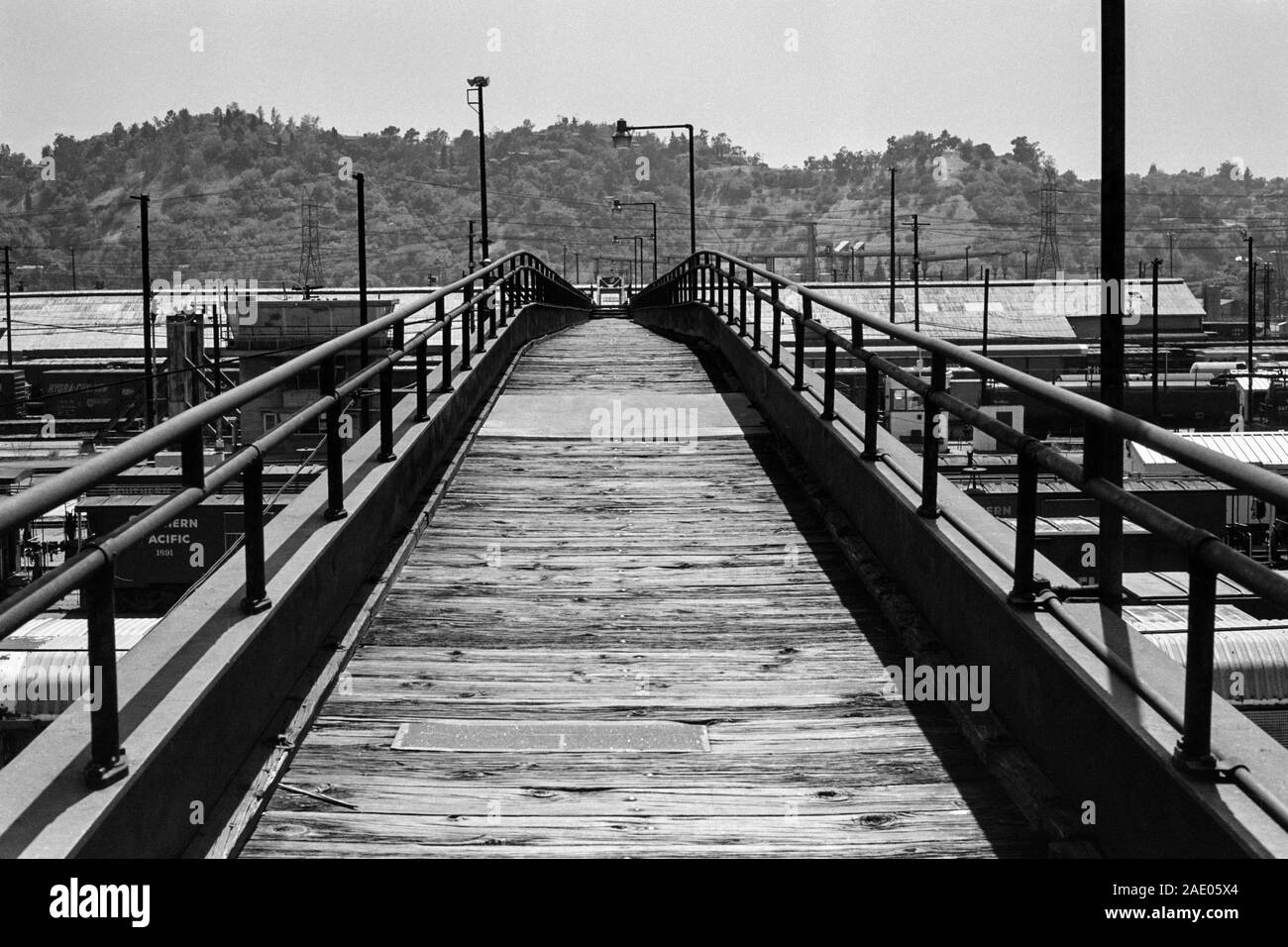 Los Angeles, California, USA - May, 1985:  Archival black and white editorial view of wood railroad yard pedestrian bridge near San Fernando Road and Stock Photo