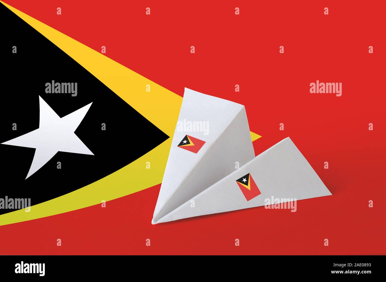 Timor Leste flag depicted on paper origami airplane. Oriental handmade arts concept Stock Photo