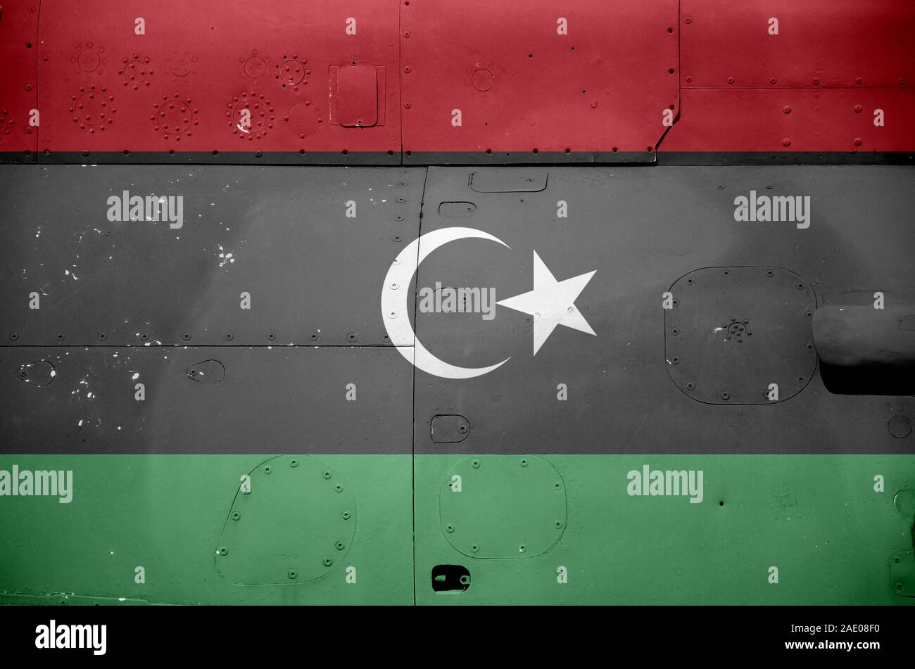 Libya flag depicted on side part of military armored helicopter close ...