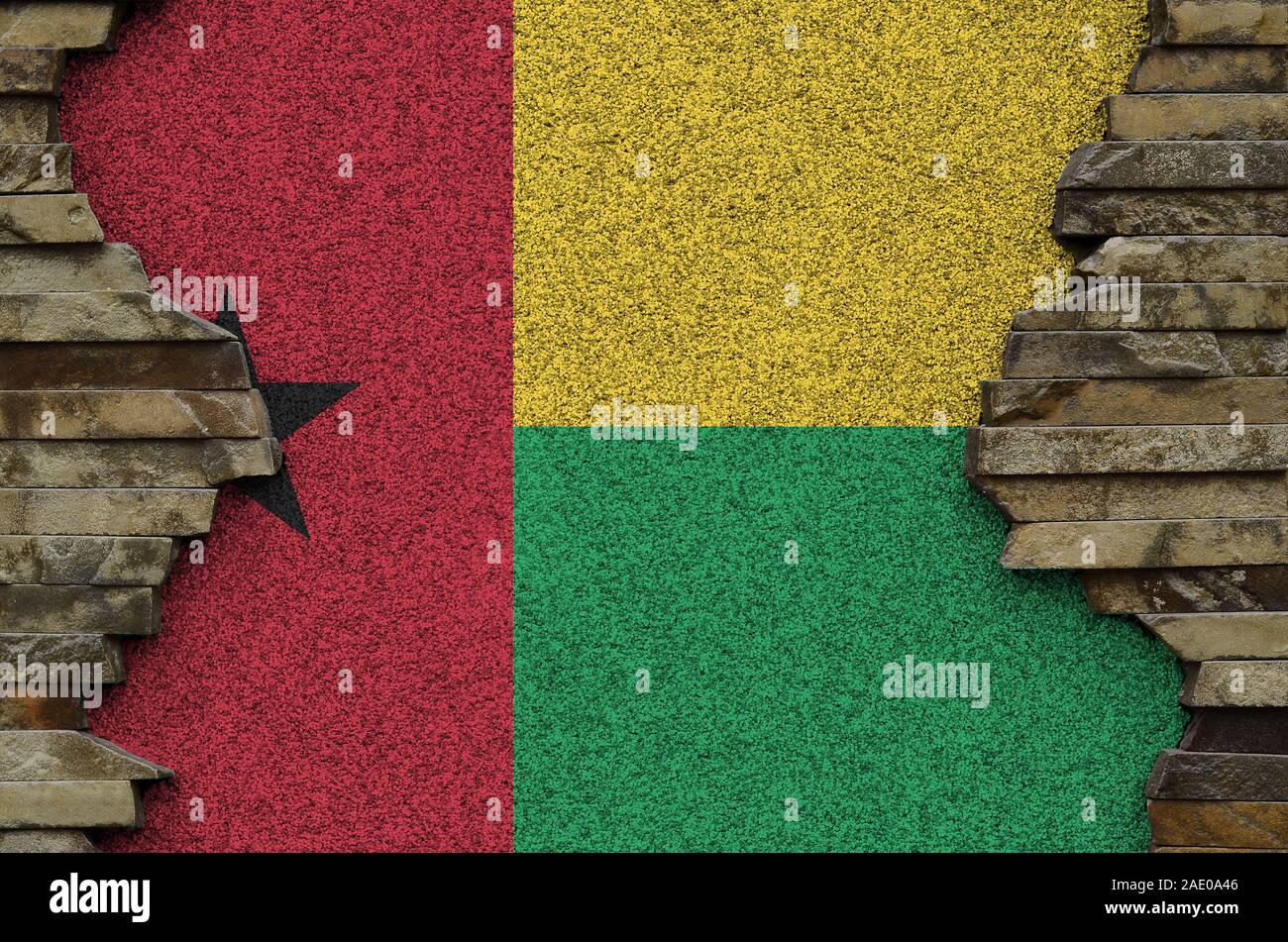 Guinea Bissau flag depicted in paint colors on old stone wall close up ...