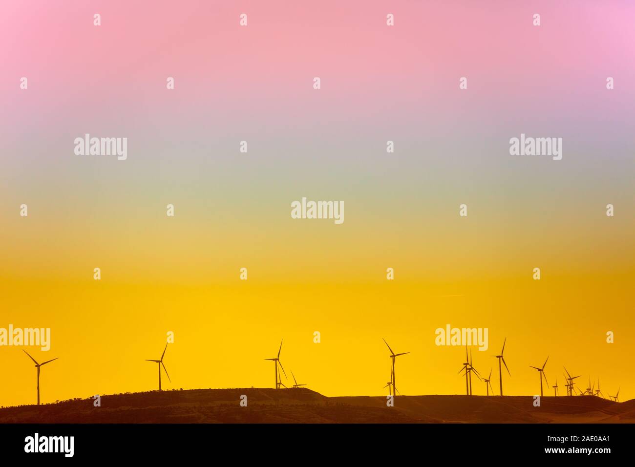 Wind generators in the field at sunset with gradient sky. Alternative ...