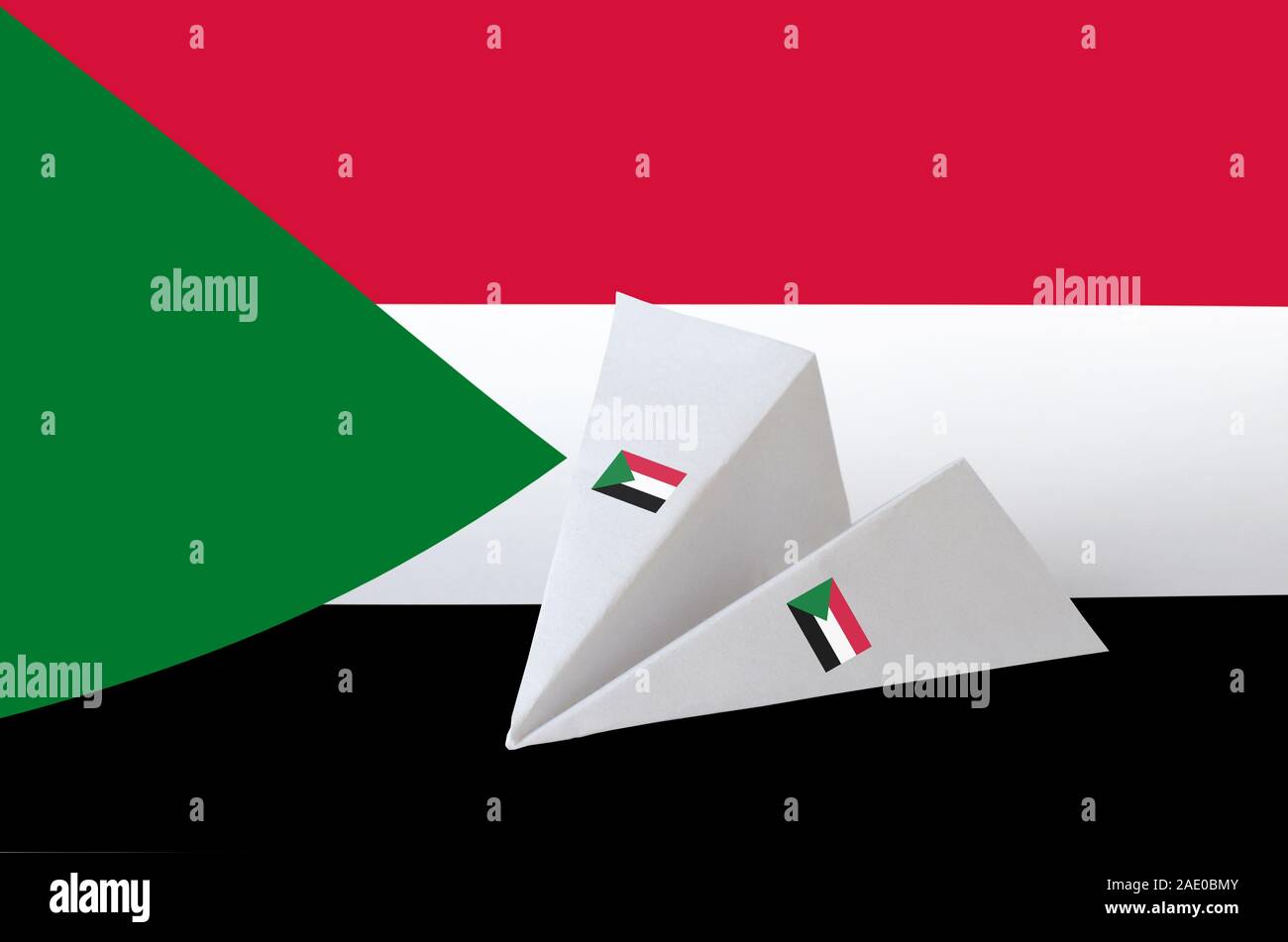 Sudan flag depicted on paper origami airplane. Oriental handmade arts ...
