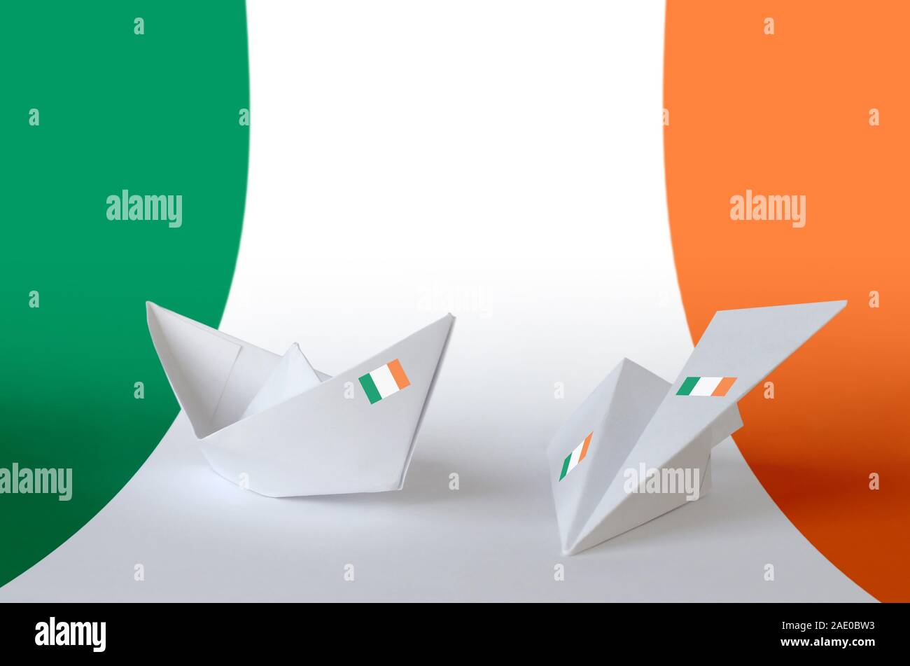Ireland flag depicted on paper origami airplane and boat. Oriental handmade arts concept Stock