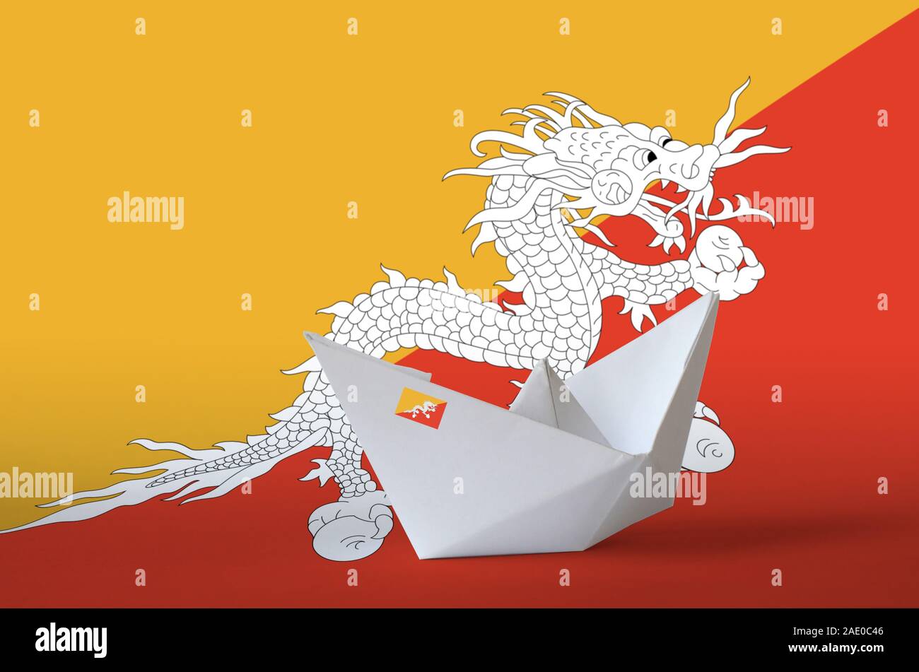Bhutan flag depicted on paper origami ship closeup. Oriental handmade ...