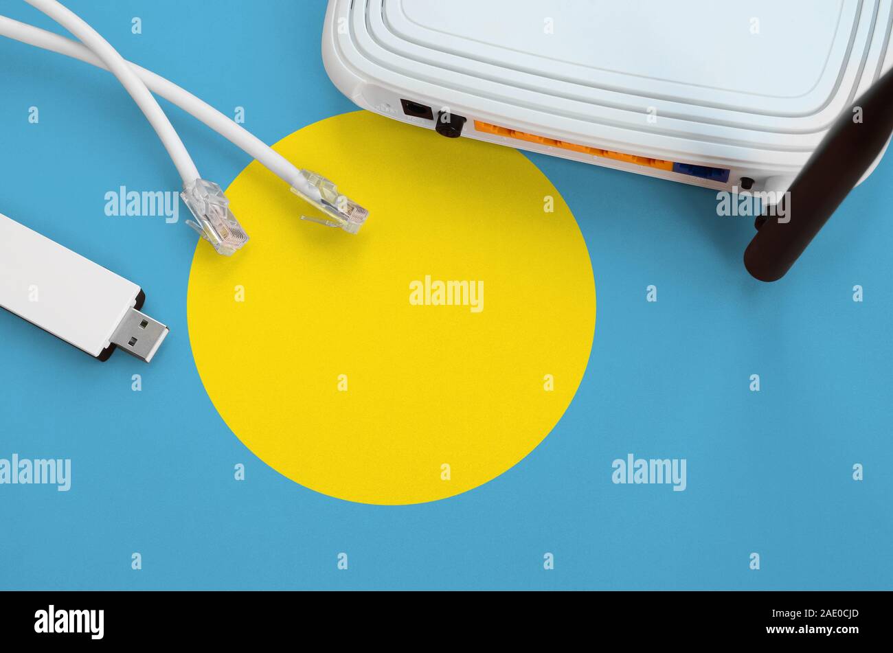 Palau flag depicted on table with internet rj45 cable, wireless usb wi-fi  adapter and router. Internet connection concept Stock Photo - Alamy