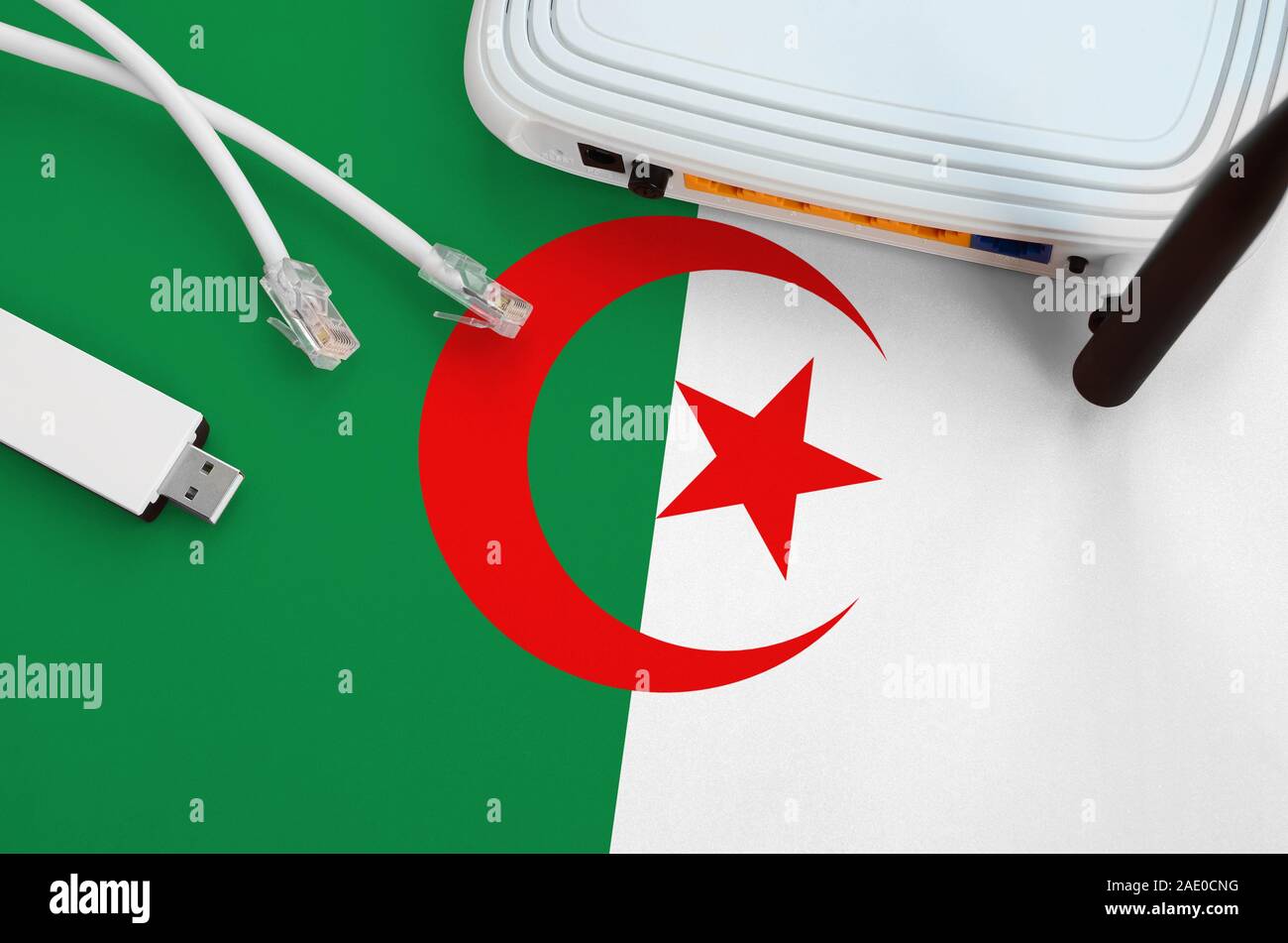 Algeria flag depicted on table with internet rj45 cable, wireless usb ...