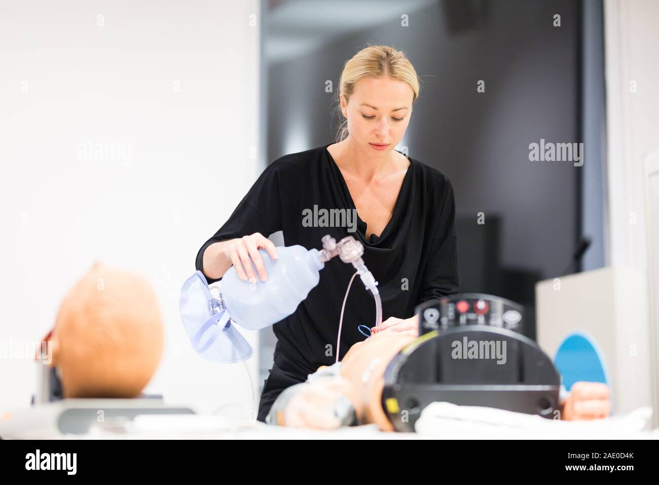 Medical doctor specialist expert displaying method of patient intubation technique on hands on medical education training and workshop Stock Photo