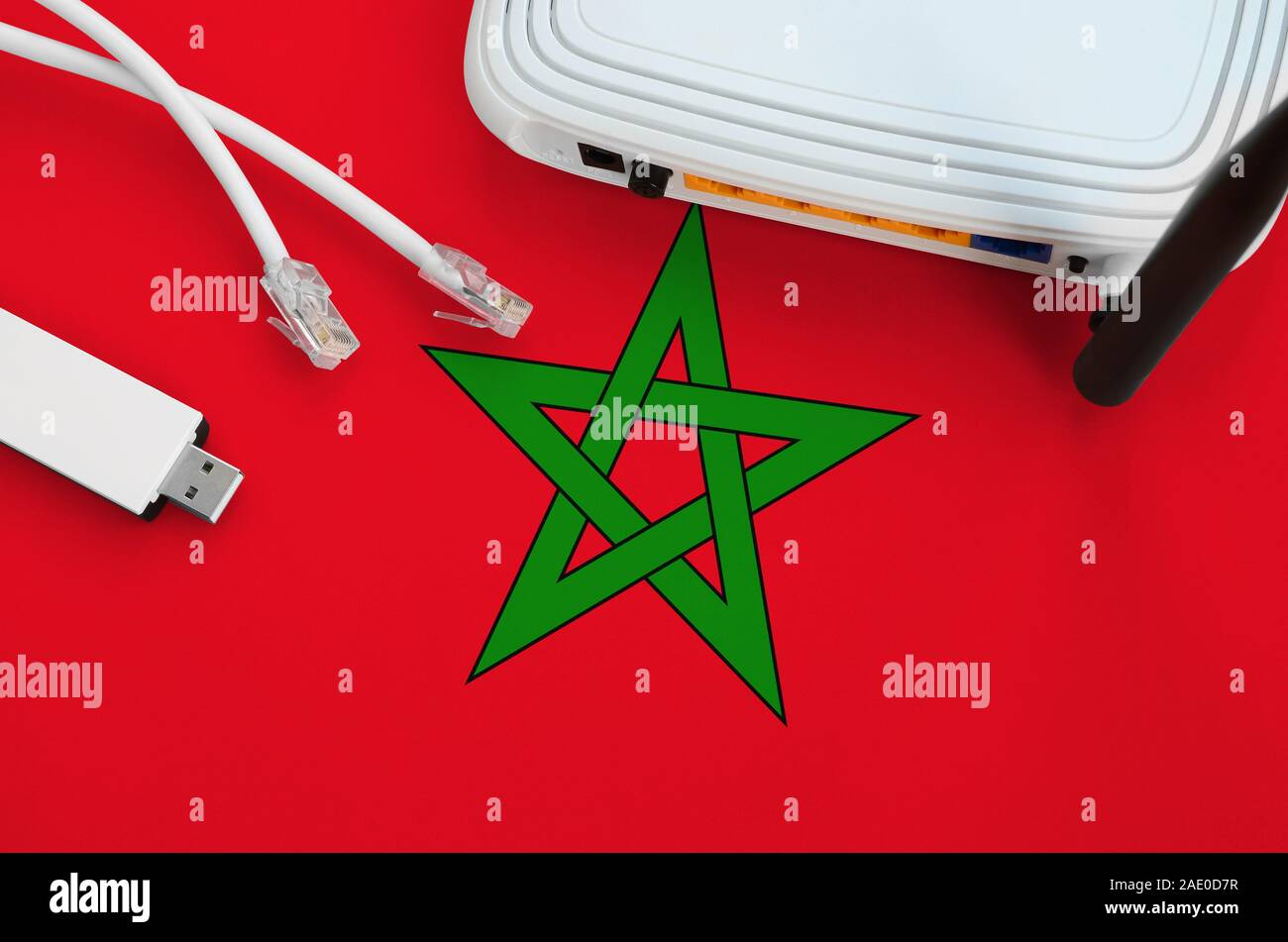 Morocco flag depicted on table with internet rj45 cable, wireless usb ...
