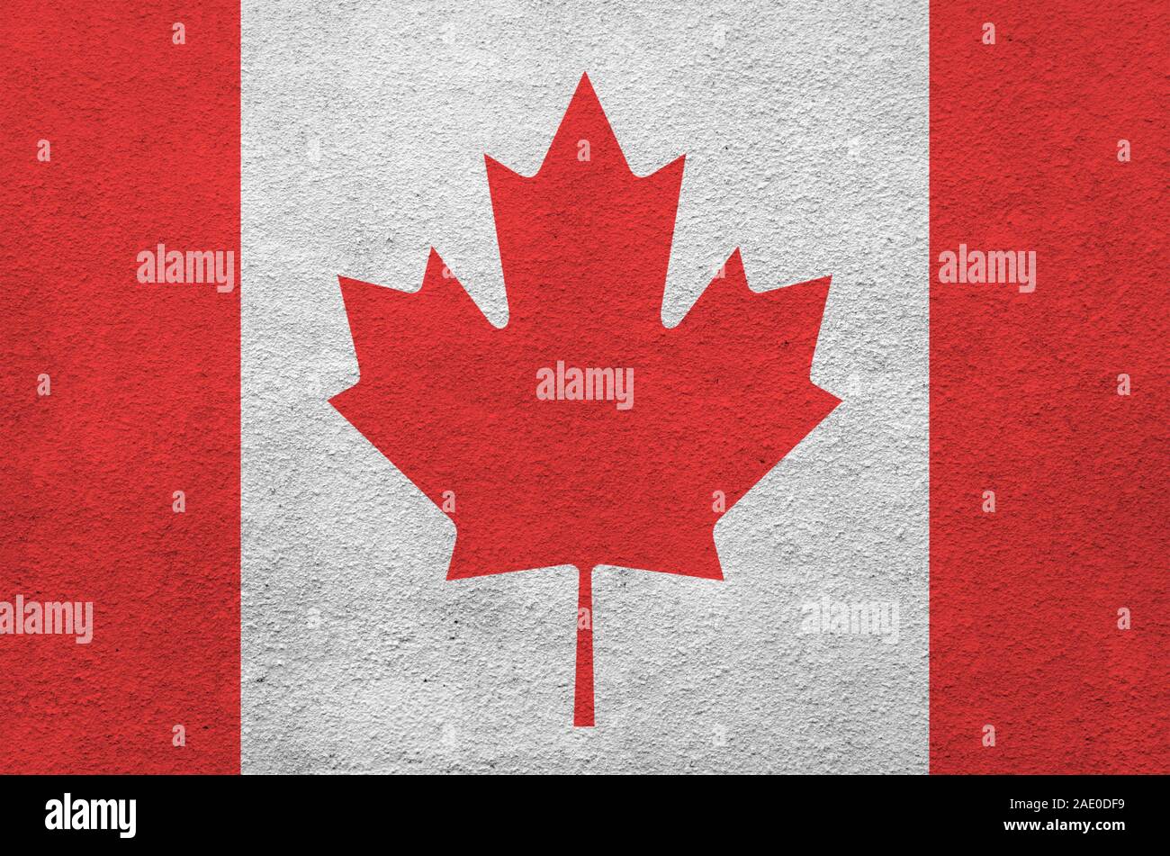 Canada flag depicted in bright paint colors on old relief plastering