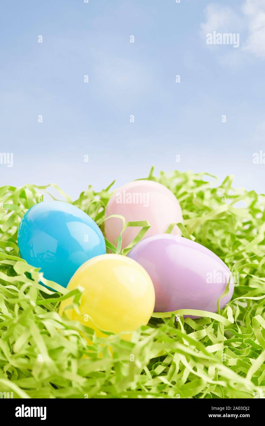Group of plastic Easter eggs sitting on artificial green grass Stock Photo
