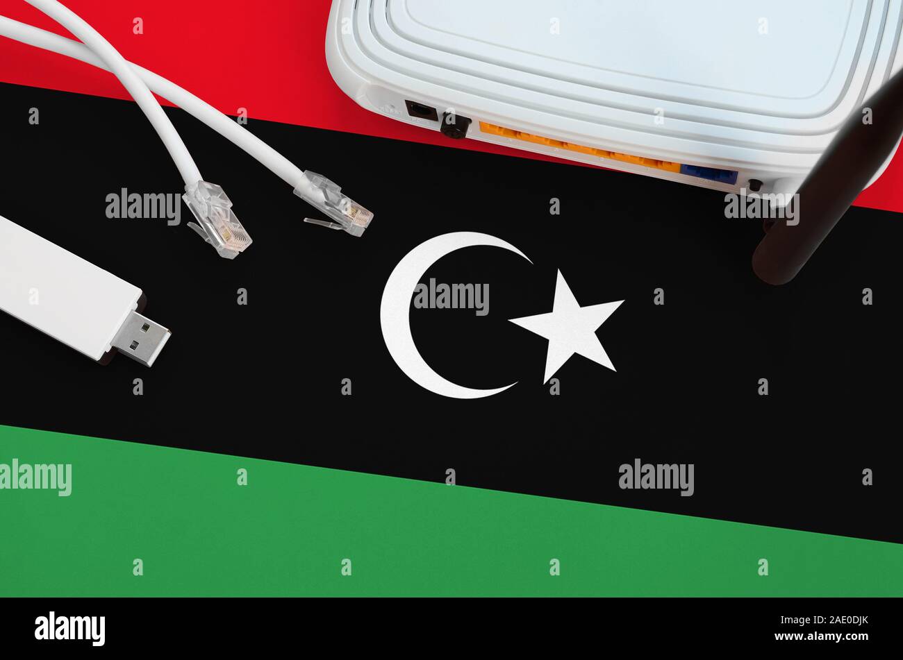 Libya flag depicted on table with internet rj45 cable, wireless usb wi ...