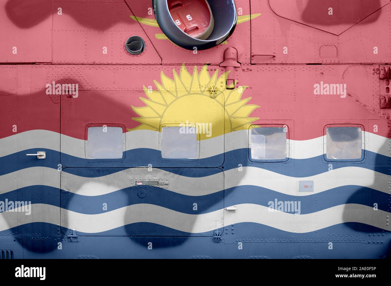 Kiribati flag depicted on side part of military armored helicopter close up. Army forces aircraft conceptual background Stock Photo
