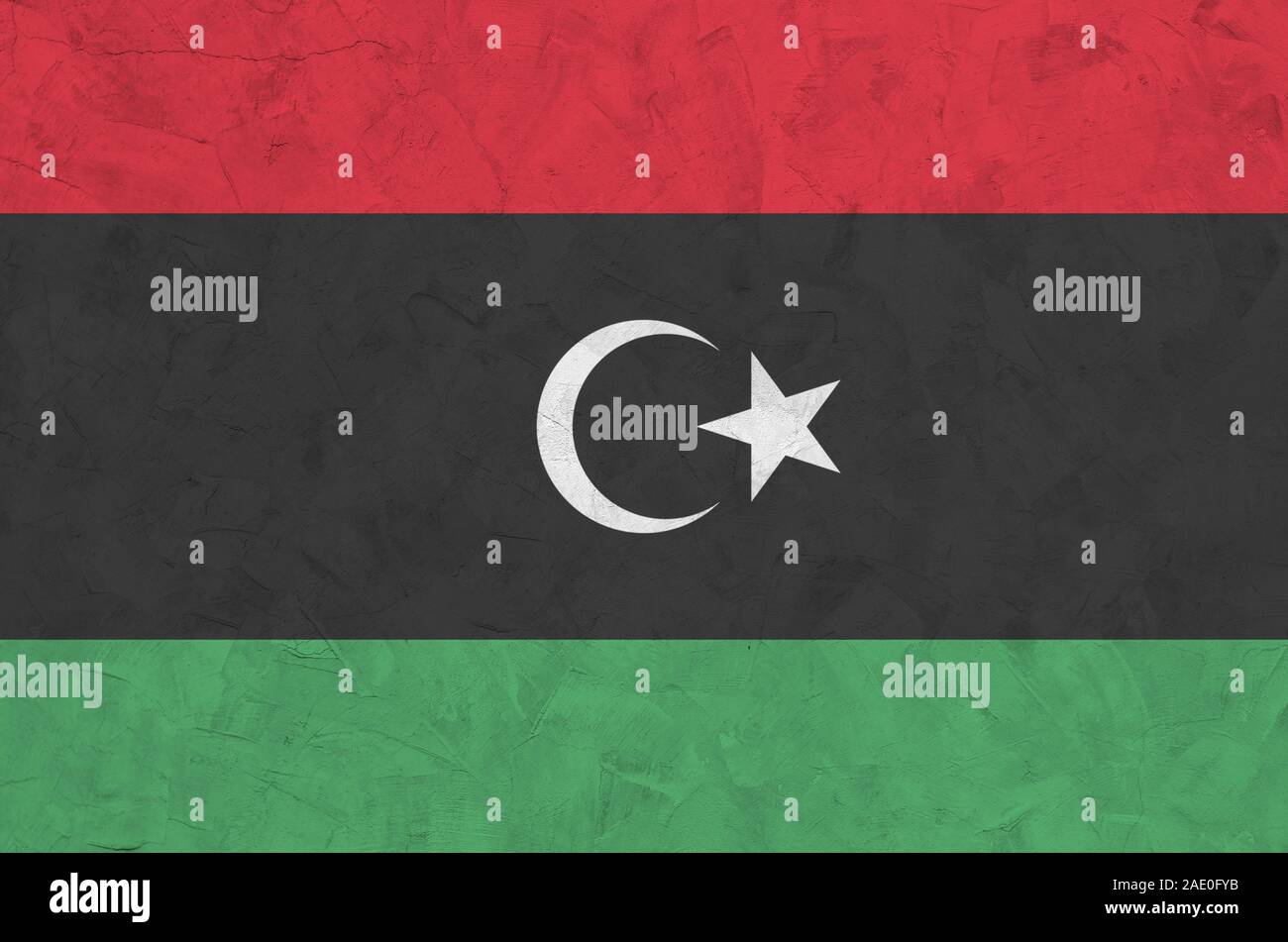 Libya flag depicted in bright paint colors on old relief plastering ...
