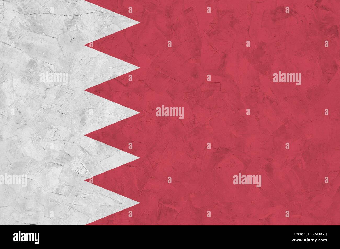 Bahrain flag depicted in bright paint colors on old relief plastering wall close up. Textured banner on rough background Stock Photo