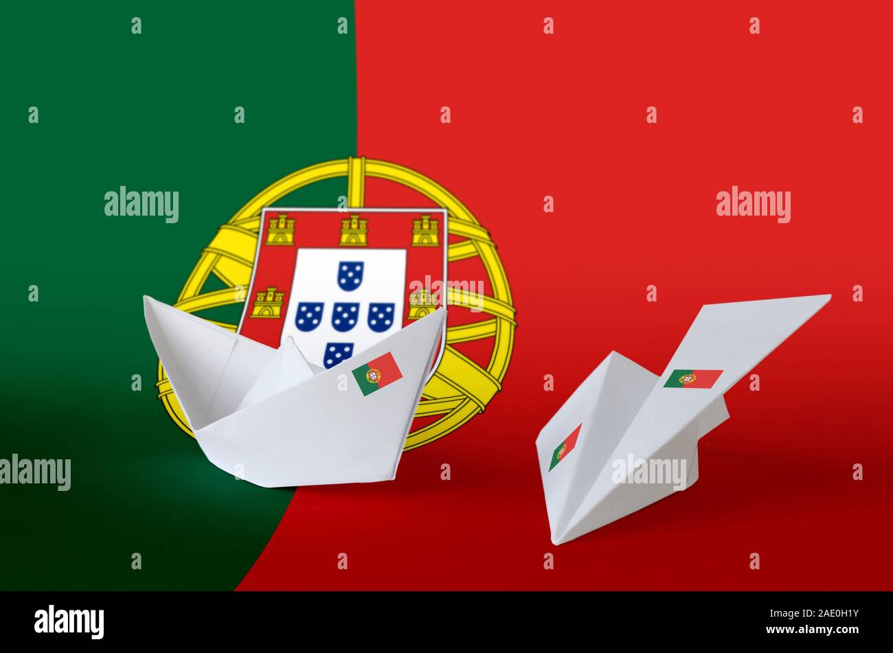Portugal flag depicted on paper origami airplane and boat. Oriental ...
