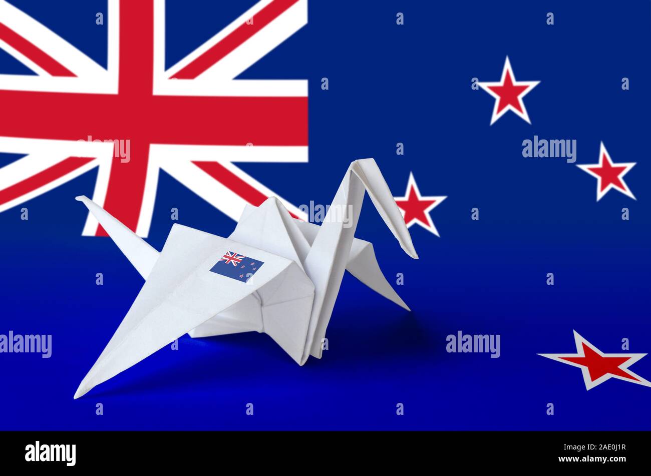New Zealand flag depicted on paper origami crane wing. Oriental