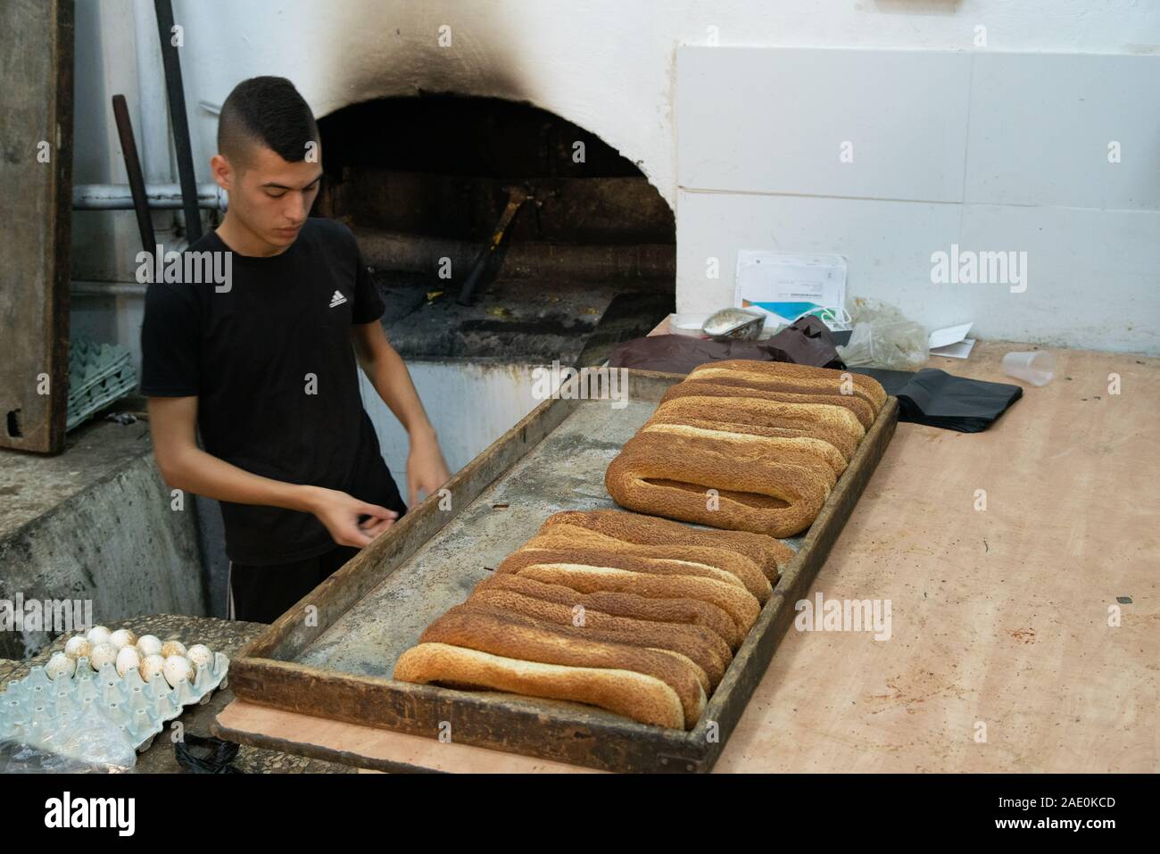 JERUSALEM, ISAREAL SEPTEMBER 2019 Young Man Baking Traditional Bread