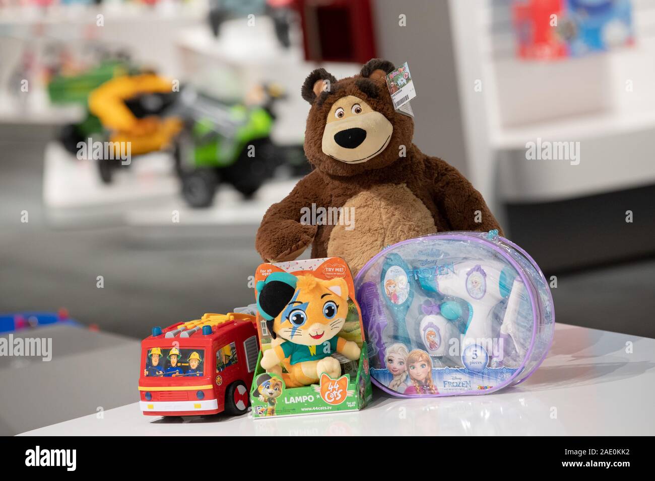 27 November 2019, Bavaria, Fürth: The toys and licensed products 'Fireman Sam' (l-r) by Dickie Toys, '44 Cats' by Smoby, the bear from 'Mascha und der Bär' by Dickie Toys and a toy beauty set with the counterfeits of the characters from the Disney film 'The Ice Queen 2' (original title 'Frozen') stand side by side at the toy manufacturer Simba Dickie Group. According to the German Toy Industry Association (DVSI), licensed products accounted for around 20 percent of the total turnover of the toy industry in 2018. (to dpa-Korr: 'The ice queen conquers the children's rooms') Photo: Daniel Karmann Stock Photo