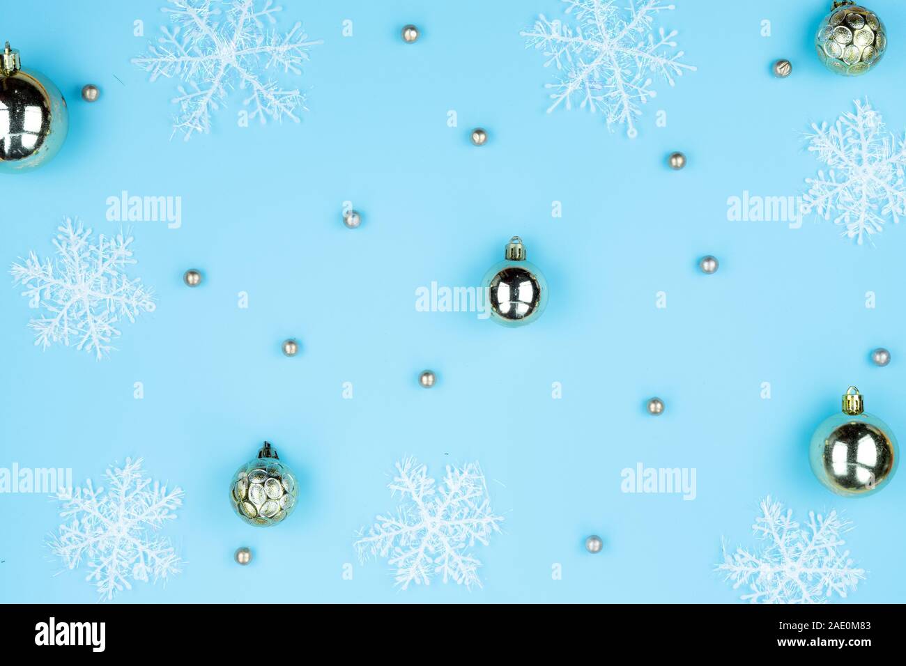 Christmas holidays composition, top view of snowflake decorations on blue background with copy space for text. Flat lay, pattern, winter, postcard tem Stock Photo