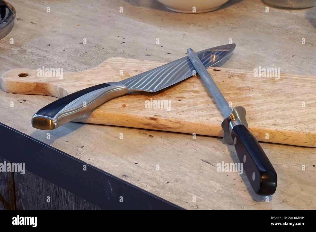 preparation for cooking sharpening a kitchen knife Stock Photo Alamy