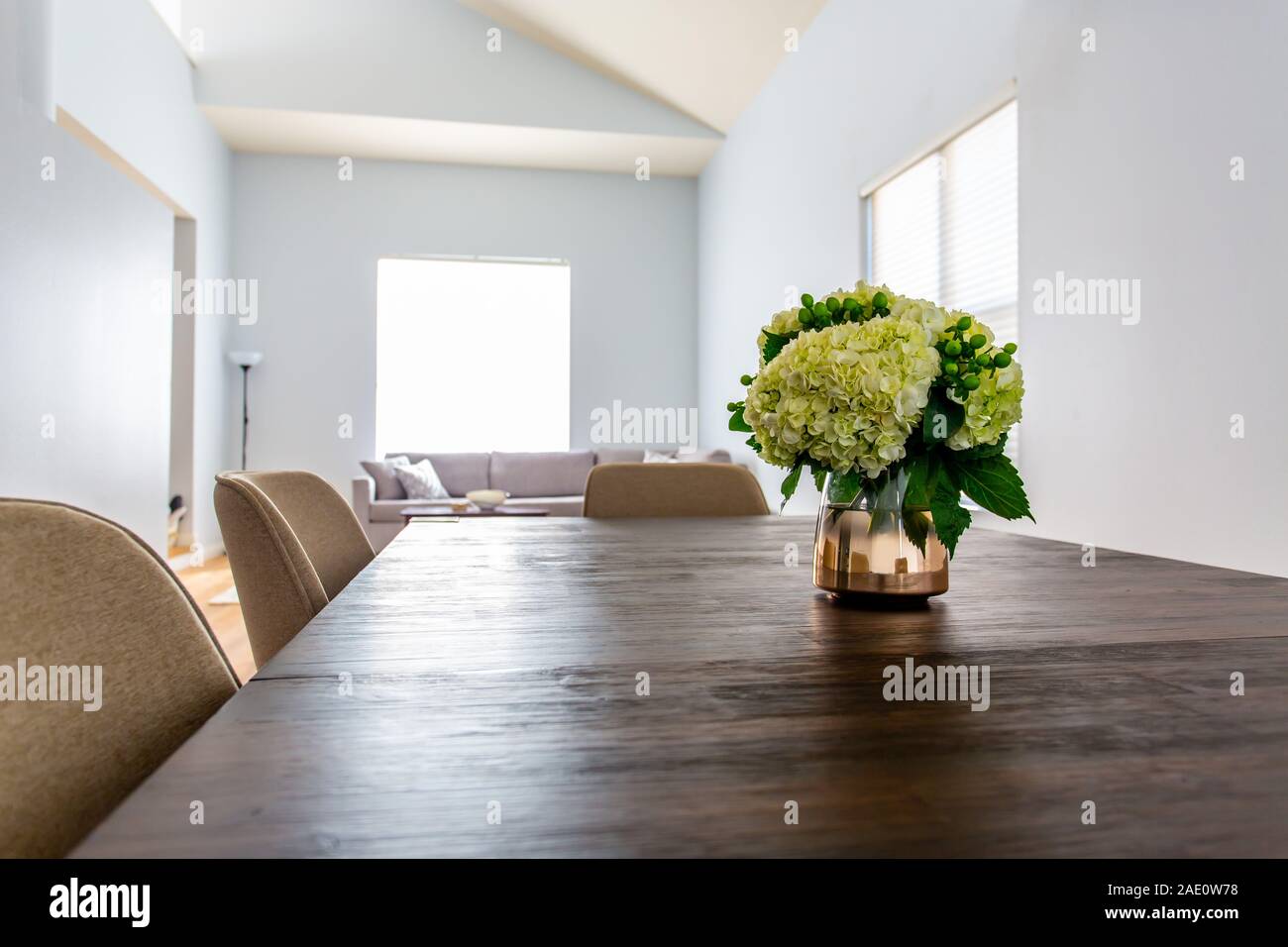 Bouquet On Wooden Dining Table Against Light Bright Walls Stock Photo