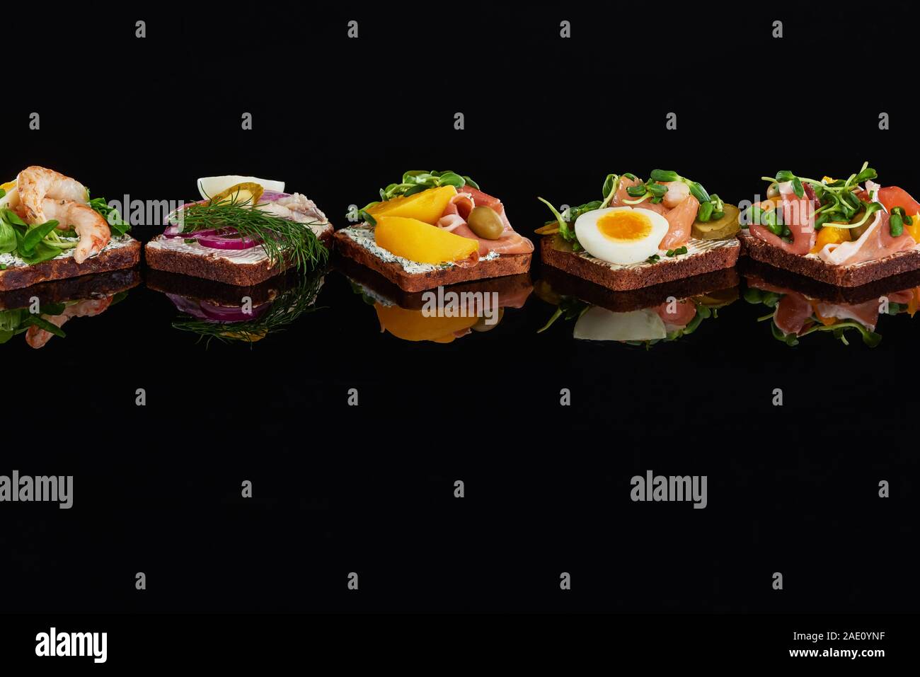 rye bread with tasty danish smorrebrod sandwiches on black Stock Photo ...