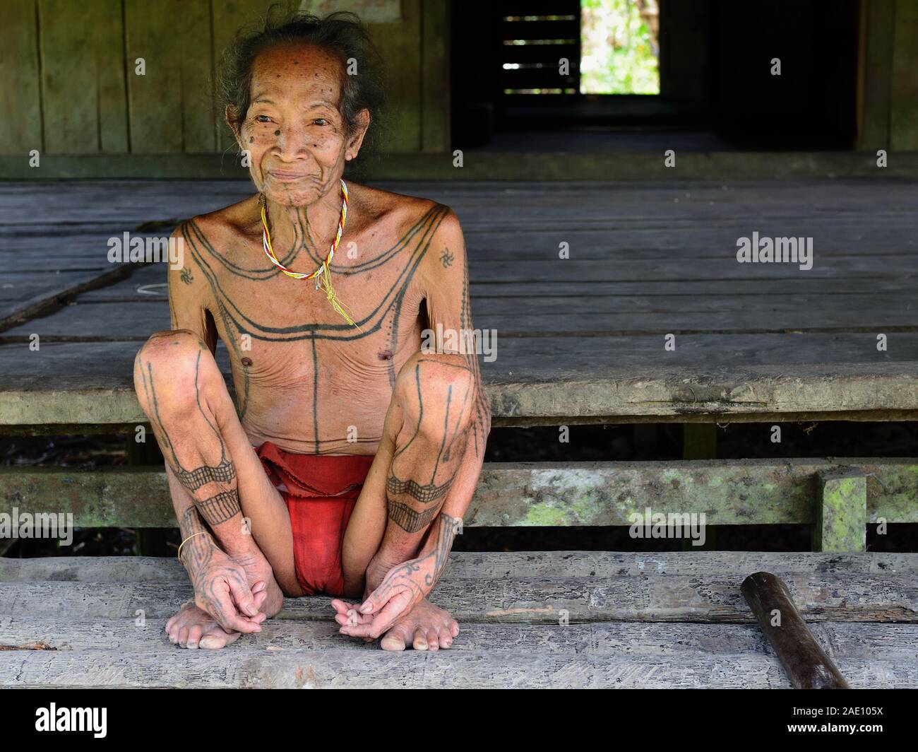 Muara Siberut, Mentawai Islands, Indonesia, NOVEMBER 5, 2019: Portrait  tribal elder man - shaman, with traditional tattoos, at his rainforest home. Stock Photo