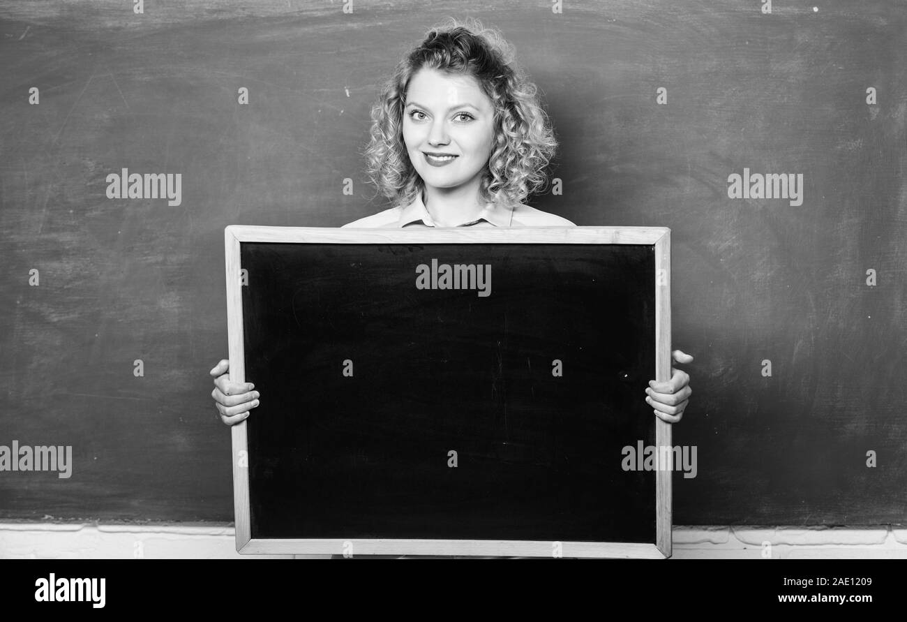 Outstanding education. informations board. announcement concept. place to write task. happy student girl hold blank board. woman teacher at blackboard. copy space. here is your advertisement. Stock Photo