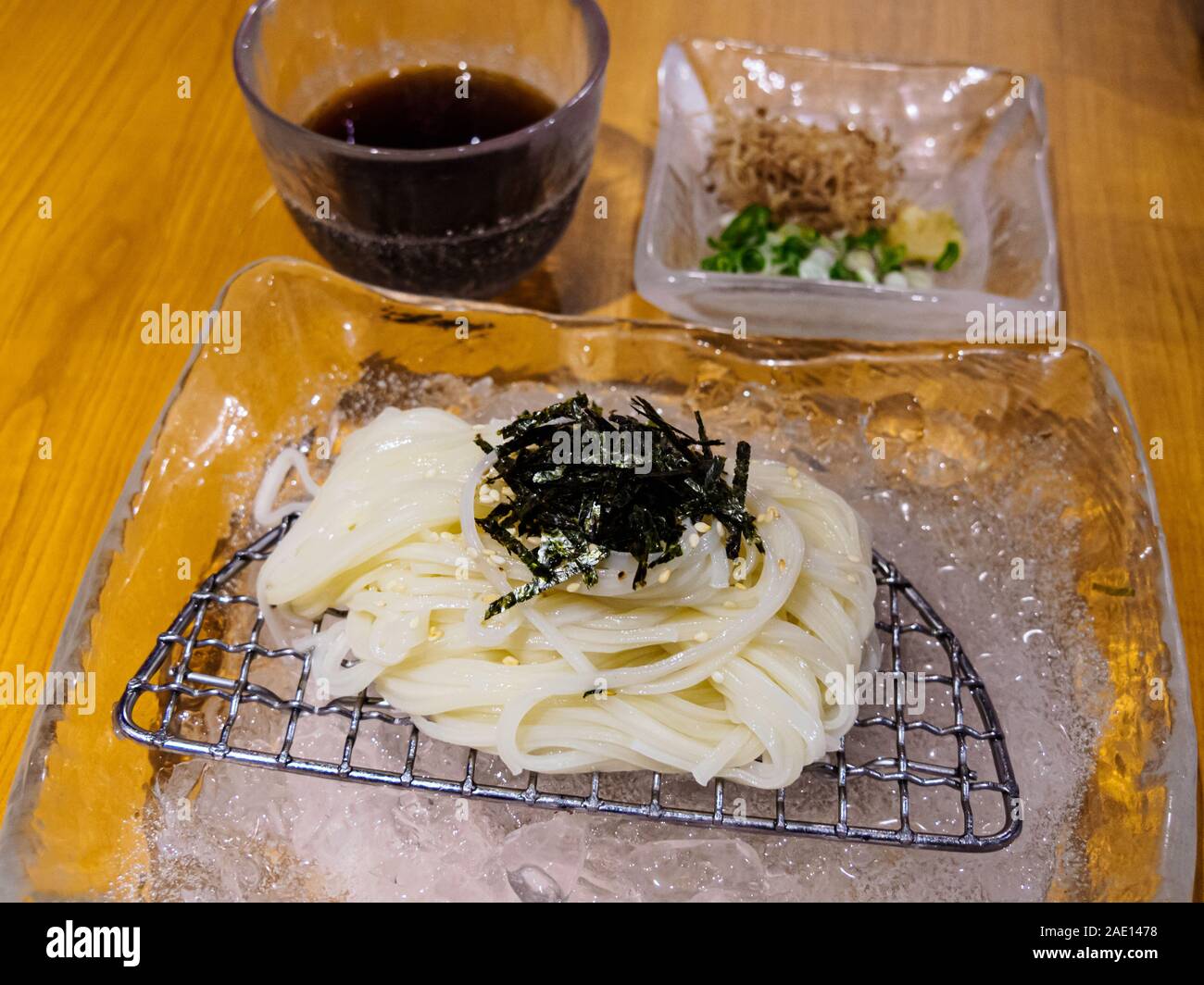Zaru Soba Japanese cold noodles with dipping sauce served over ice at a Japanese restaurant. A popular summer dish. Stock Photo