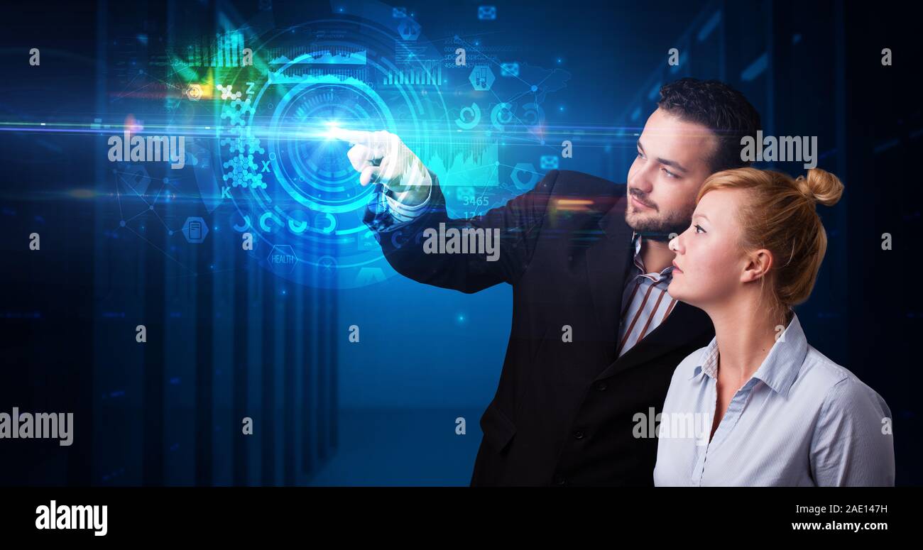 Man and woman touching hologram screen displaying medical symbols and charts Stock Photo