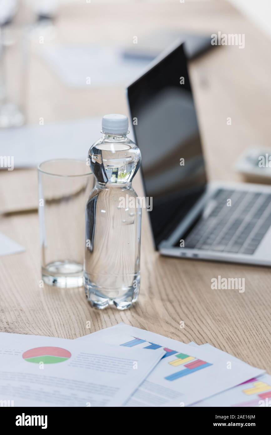 Download Selective Focus Of Bottle And Glass Of Water Near Laptop And Papers With Infographics On Wooden Table In Meeting Room Stock Photo Alamy Yellowimages Mockups