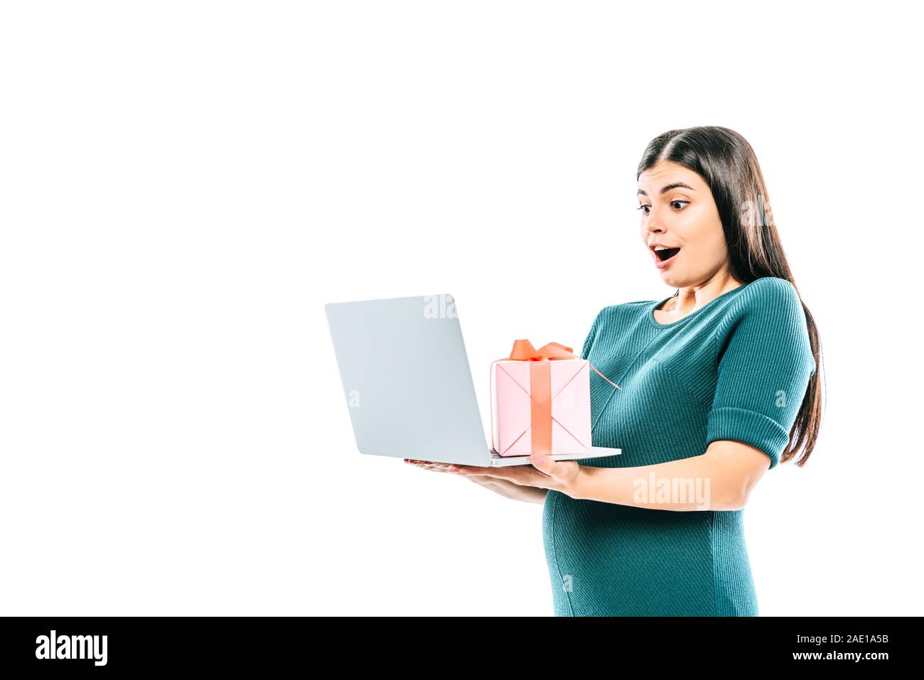 shocked pregnant girl holding laptop and gift isolated on white Stock Photo