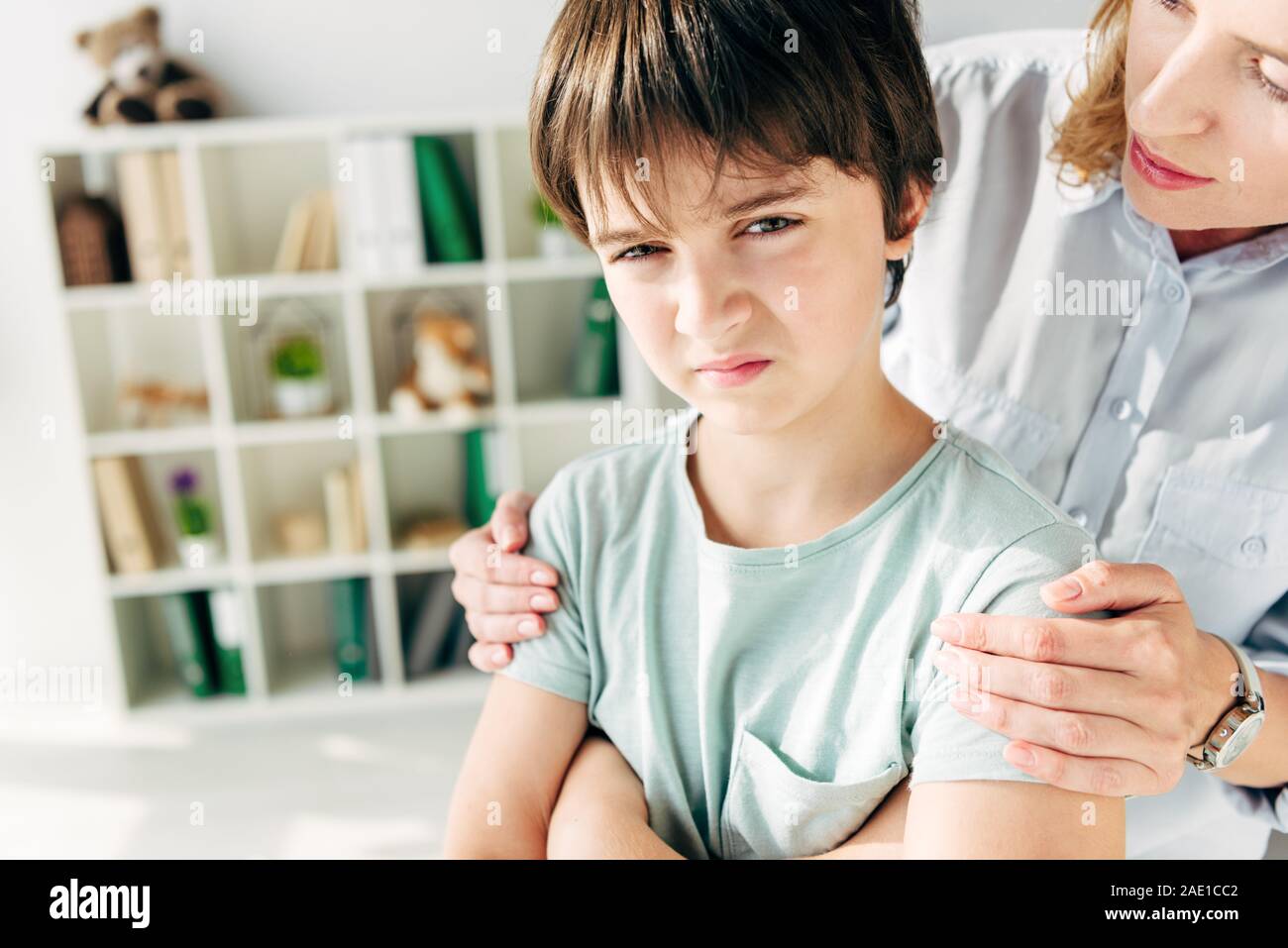 cropped view of child psychologist hugging kid with dyslexia Stock ...