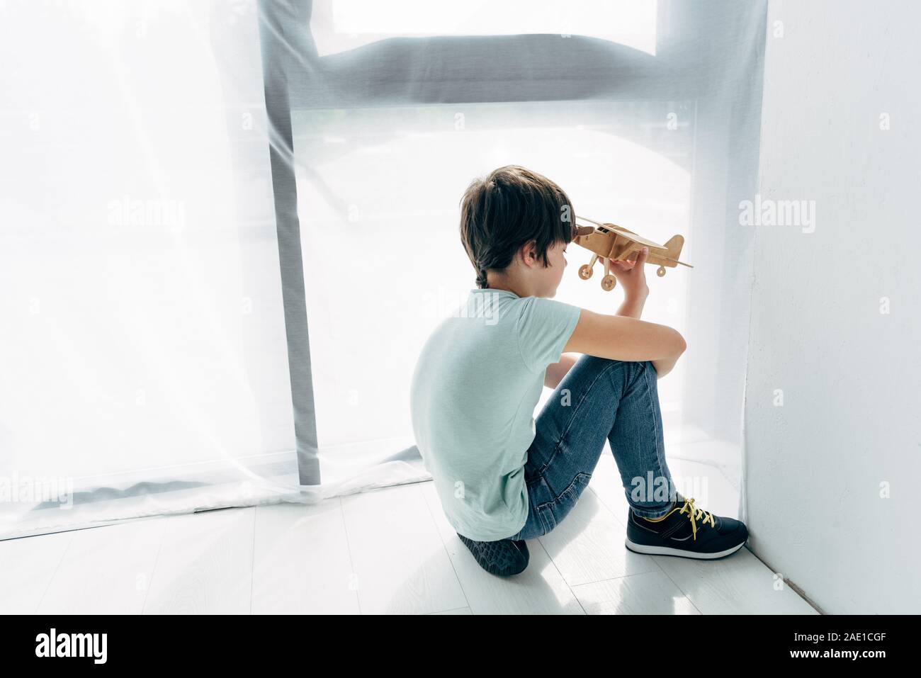 high angle view of kid with dyslexia sitting on floor and playing with ...