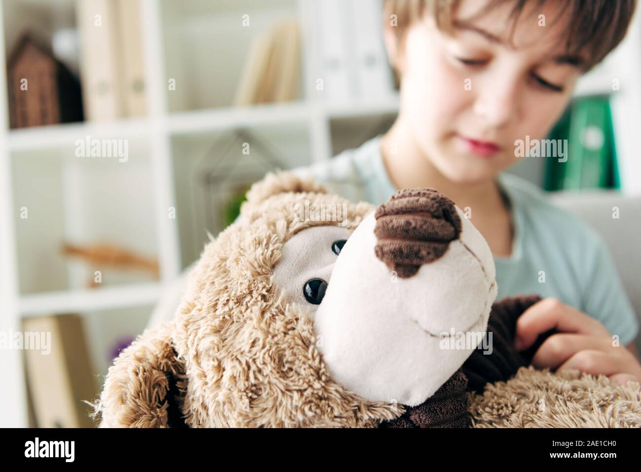 selective focus of kid with dyslexia holding teddy bear Stock Photo - Alamy