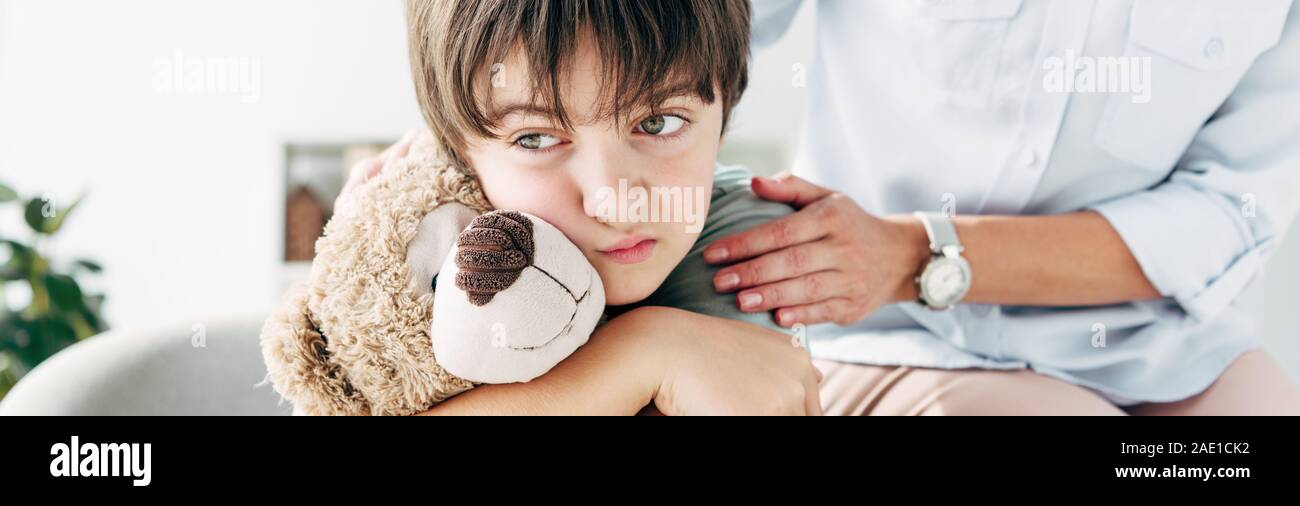 panoramic shot of kid with dyslexia holding teddy bear and child ...