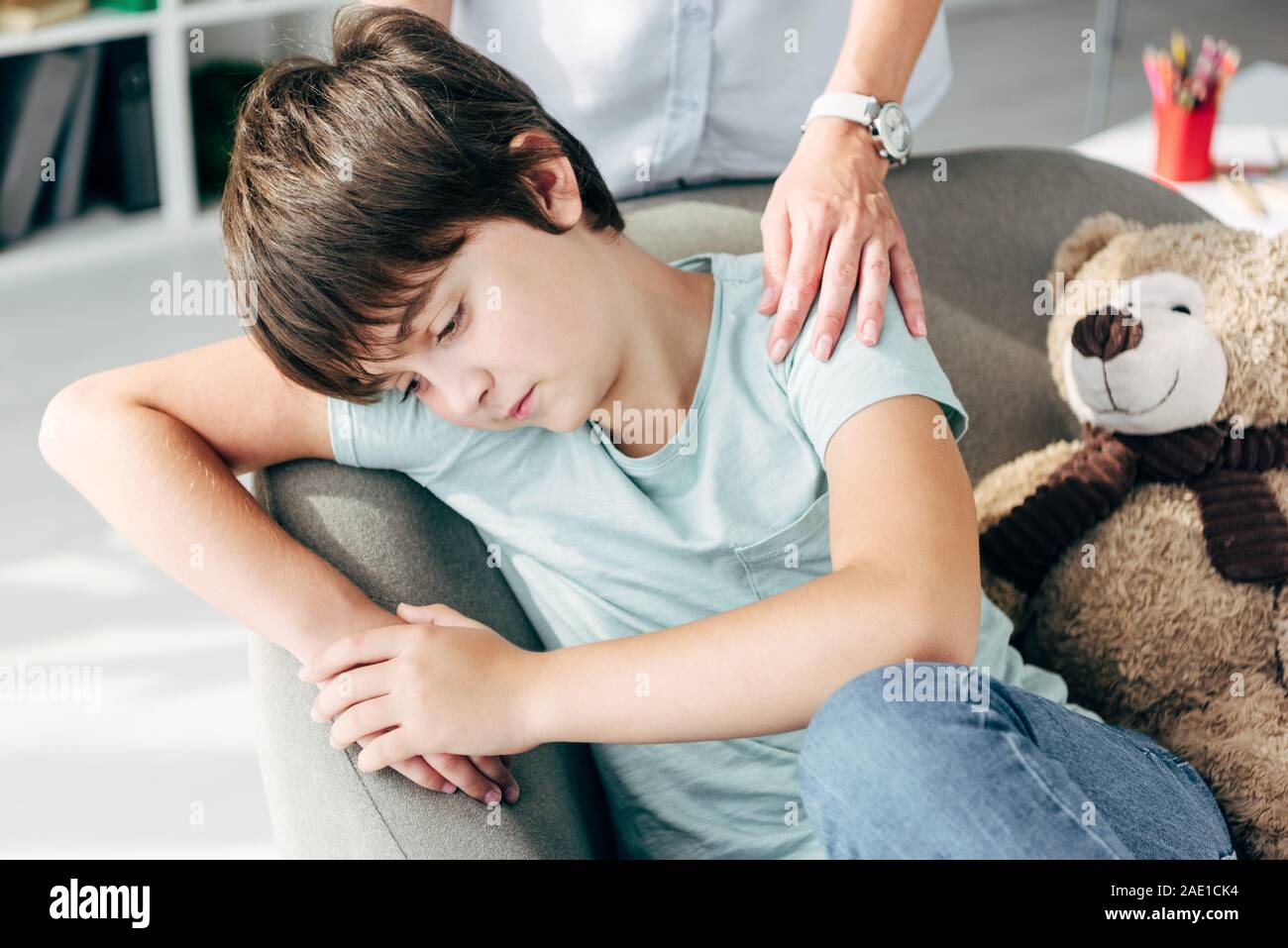 cropped view of child psychologist hugging sad kid with dyslexia Stock ...