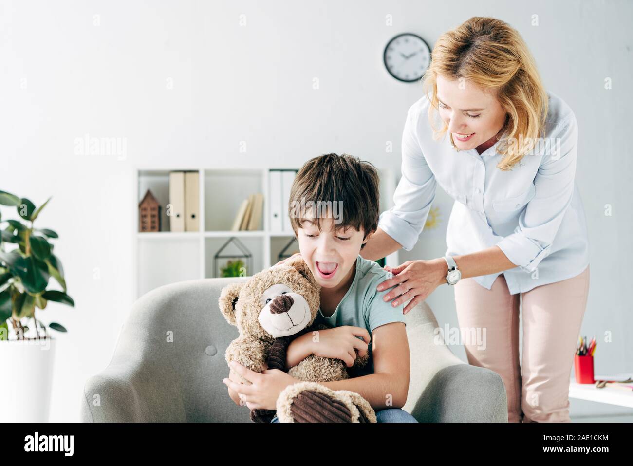 shocked kid with dyslexia holding teddy bear and smiling child ...