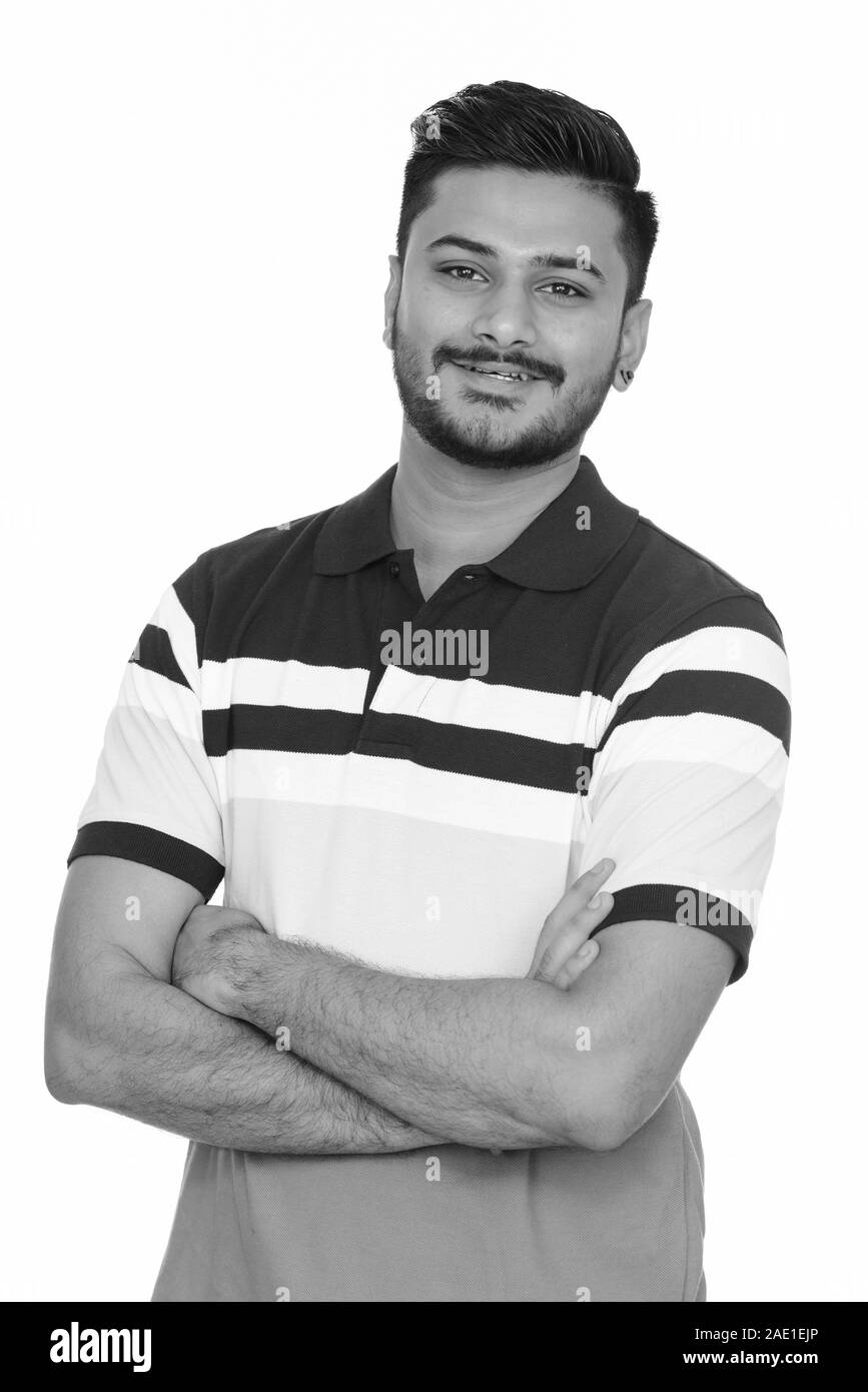 Young happy handsome Indian man smiling with arms crossed Stock Photo ...