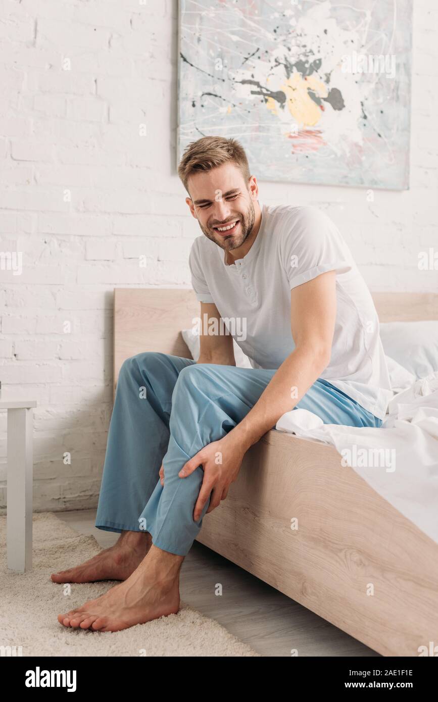 upset man touching leg while suffering from calf muscle pain Stock Photo