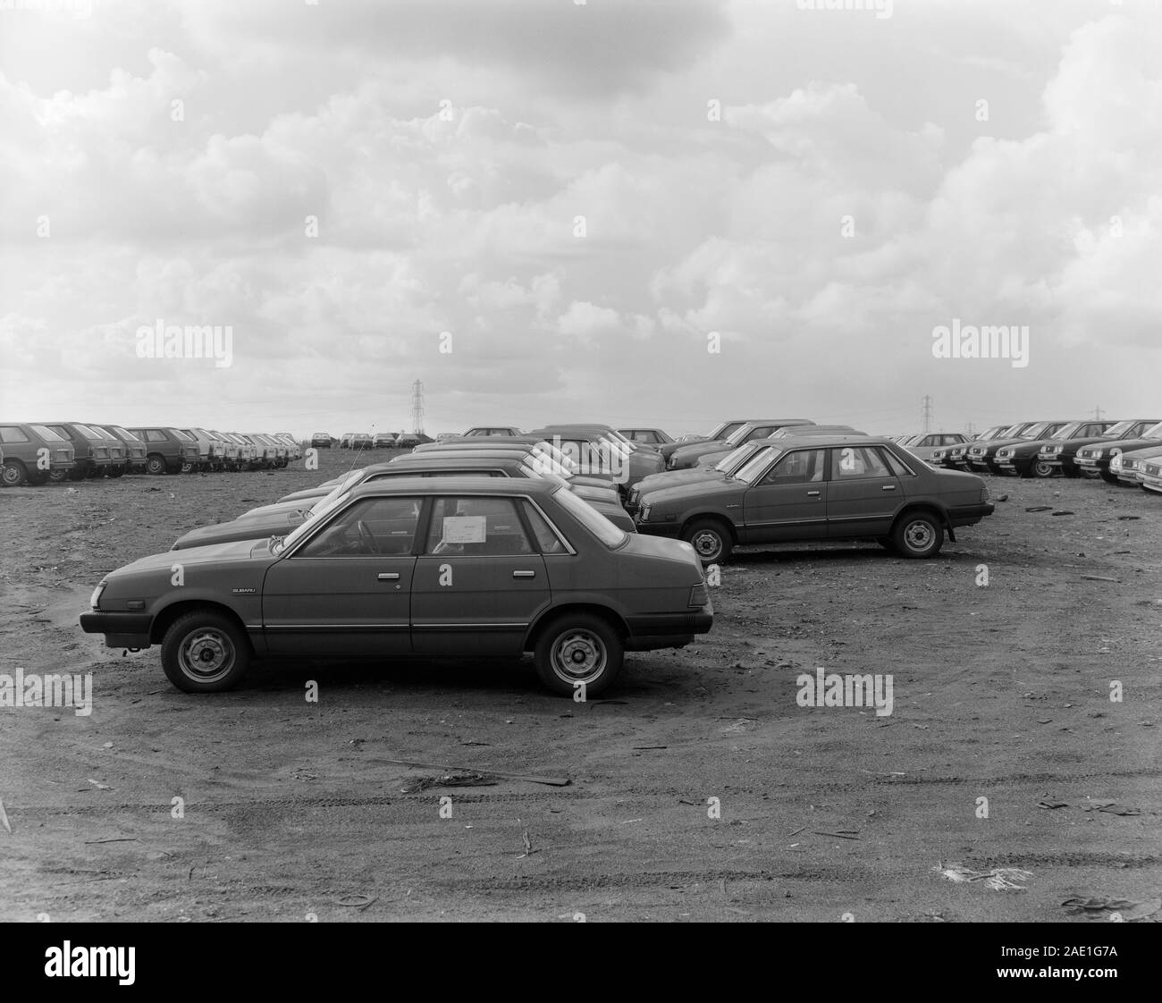 Imported cars waiting delivery in UK port 1982 Stock Photo