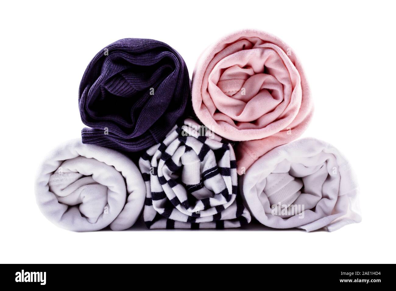 Vertical storage of clothing in rolls. Minimalism color scheme. T