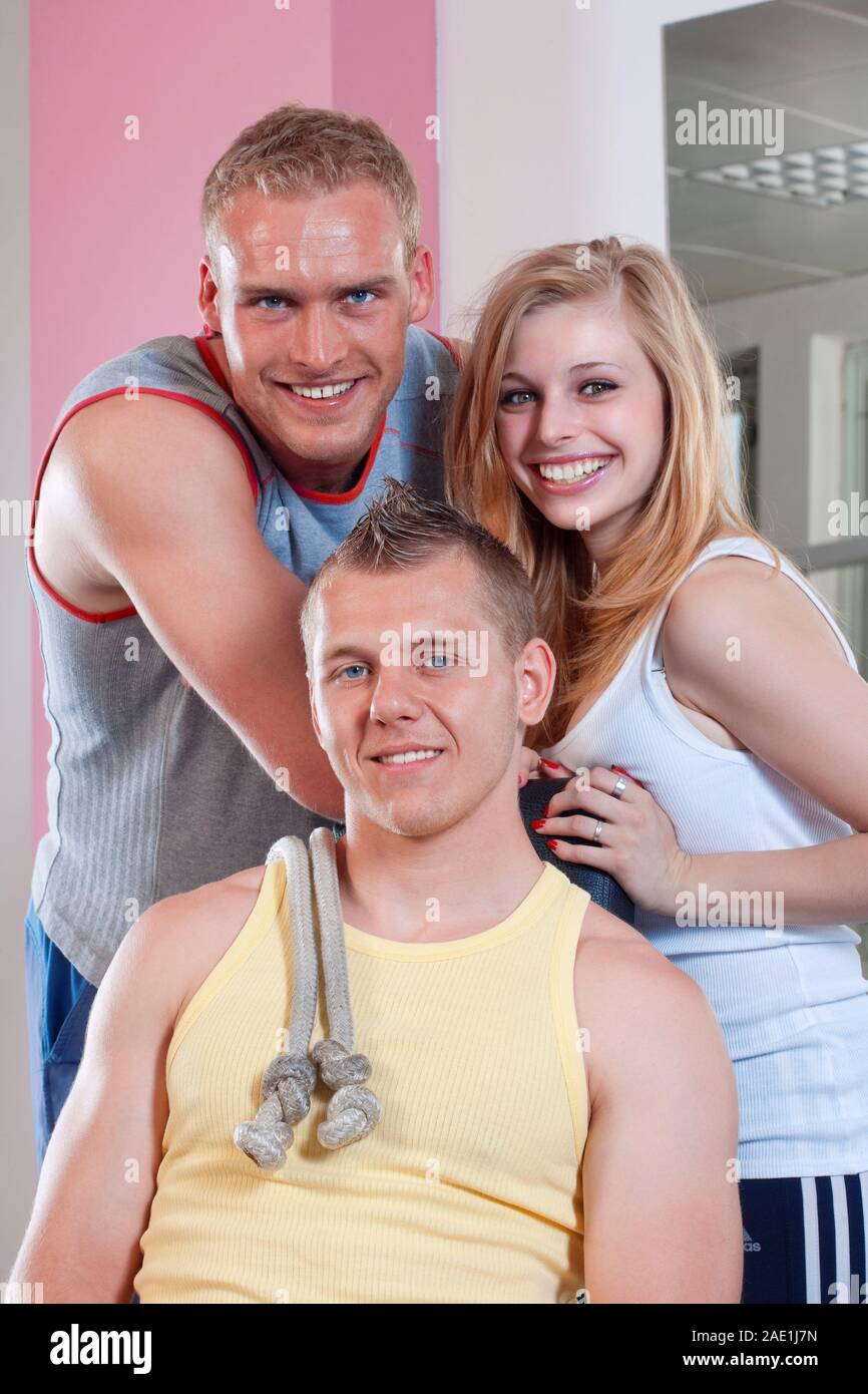 portrait of  three fit young people in modern gym Stock Photo