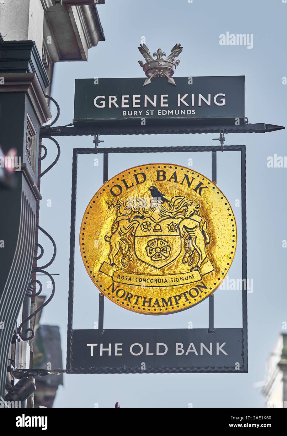 Round, golden sign outside the old bank building (now a Green King pub) in the town center of Northampton, England. Stock Photo