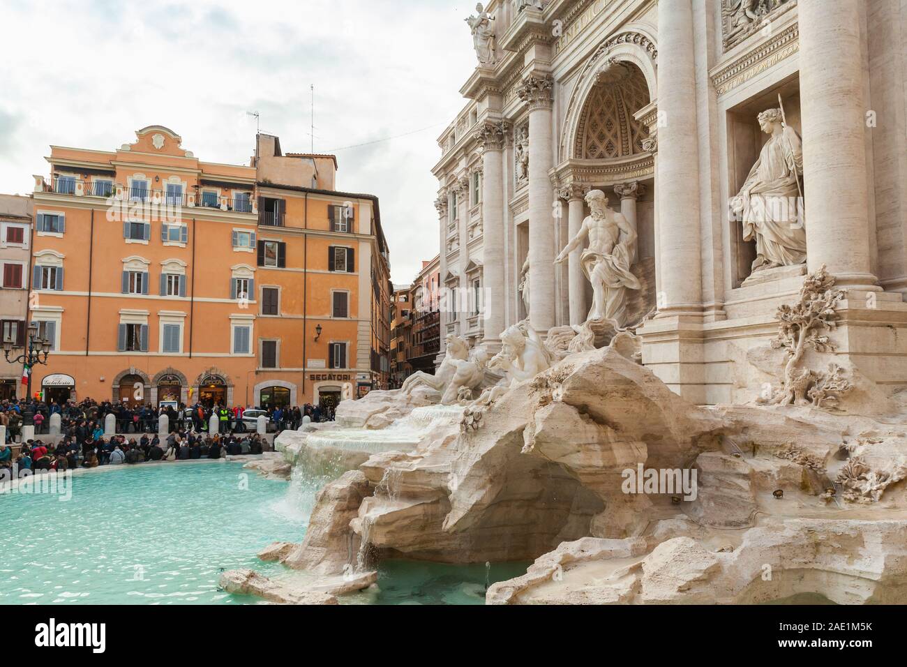 Rome, Italy - February 13, 2016: Tourists are near the Trevi Fountain. It is one of the most popular tourist attractions in Rome Stock Photo