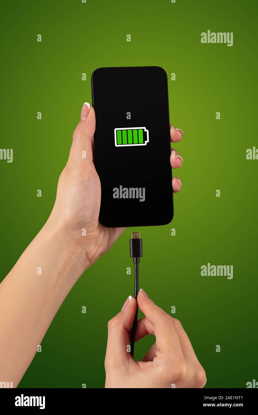 Elegant hand charging cellphone with low battery Stock Photo Alamy